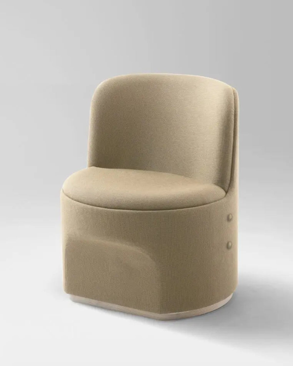 A modern low-profile accent chair upholstered in a textured beige fabric, featuring a rounded backrest and a sculptural base with two small side buttons, set against a neutral gray studio background.