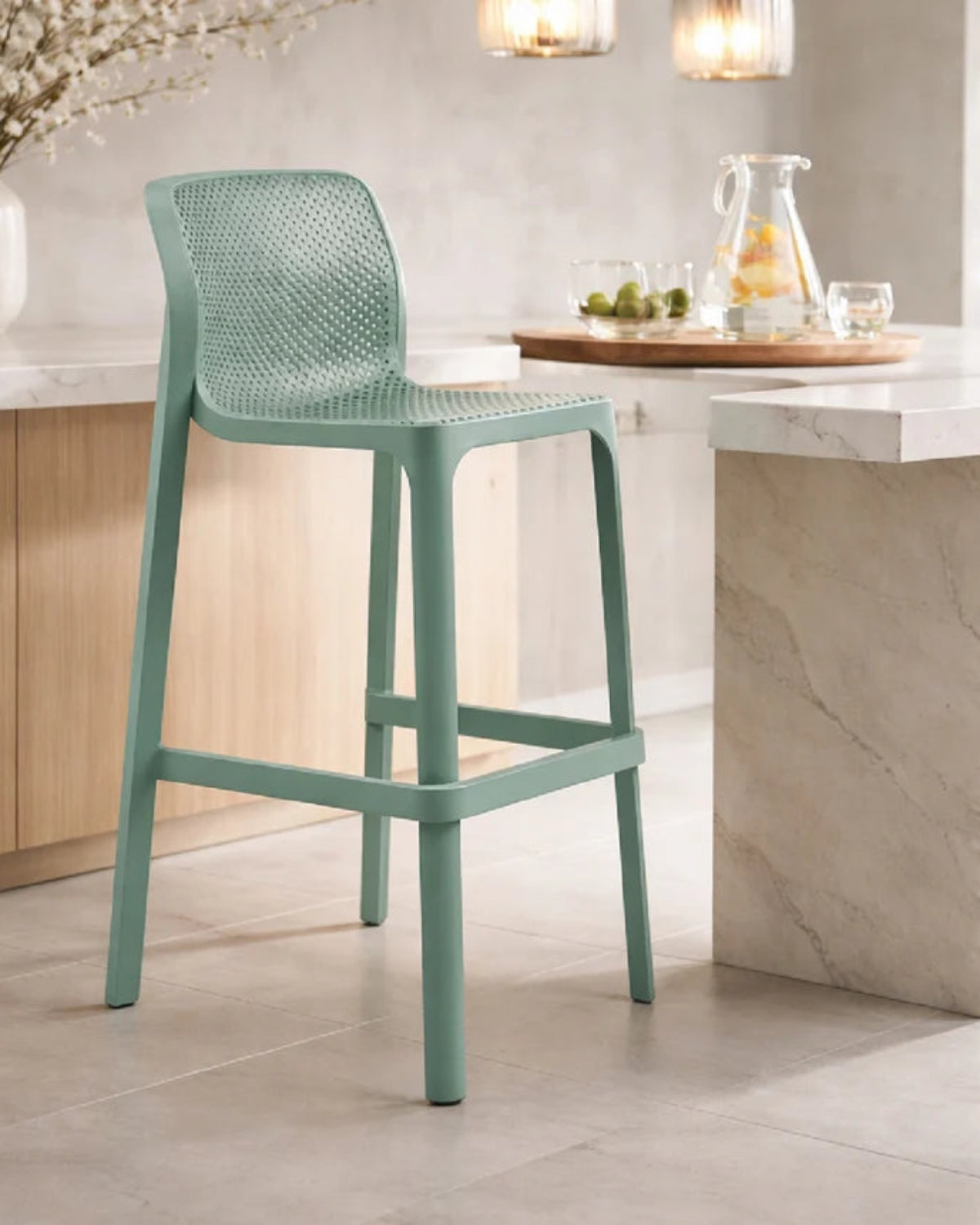 Green bar stool in a kitchen setting with a neutral color palette