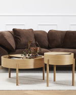 Arc Side Table in oiled oak with lid open showing hidden storage lined with smooth nanolaminate, three-legged Scandinavian design.