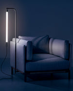 Baia lamp in darkness, attached to bottom of one seater couch.