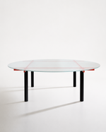 A modern round glass-top table with a black metal frame and four legs, accented by thin red lines on the glass and small red brackets under the rim, shown on a clean white studio background.