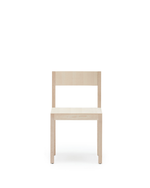 A minimalist light natural wood chair with a rectangular backrest and seat, shown from the front against a solid white background.