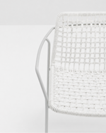 Close-up of a white woven chair seat and back with a white metal frame against a clean white background.