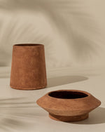 Two terracotta pots on a beige background