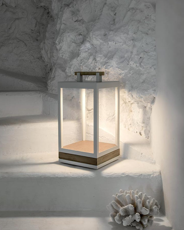 Carre Table Lamp in pickled tea textured matt warmwhite and sitting pn a painted white step of a staircase.