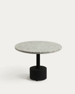 A modern round side table with a light gray speckled stone top and a matte black cylindrical pedestal base, photographed against a clean off-white background.