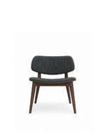A mid-century modern accent chair featuring a dark gray and black textured bouclé upholstered seat and backrest, supported by a dark brown wooden frame with tapered legs, shown against a plain white background.