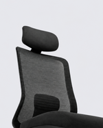 A modern ergonomic office chair with a black mesh back, padded headrest, curved seat, and black five-star wheeled base, shown against a light gray studio background.