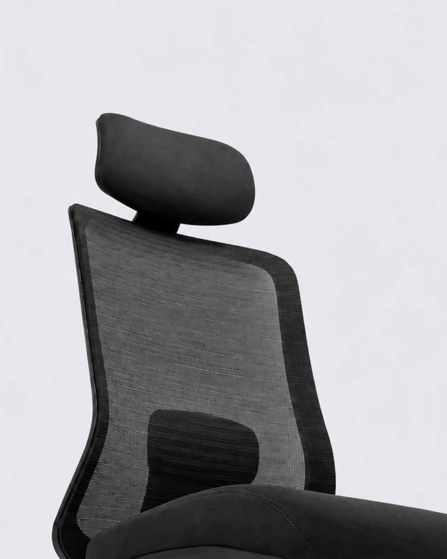 A modern ergonomic office chair with a black mesh back, padded headrest, curved seat, and black five-star wheeled base, shown against a light gray studio background.