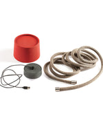 Red container, coiled beige cable, and black extension cord on a white background
