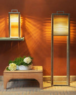 Ginger Lamps in size tall and table nxt to each other, turned on and lighting up the orange wall behind them.