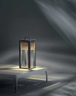 Ginger Table Lamp lit up in dark room and placed on a low white table.