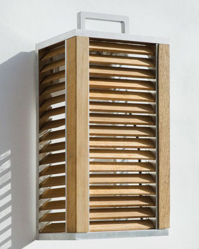 Ginger Wall Lamp hanging from a white wall, outdoors.