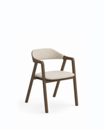 A modern dining chair with a dark brown wooden frame and light beige textured fabric upholstery on the seat and curved backrest, shown against a plain white background.