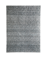 A rectangular area rug with a textured, abstract pattern in shades of gray and silver, shown flat against a white background.