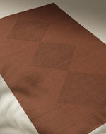 Brown textured mat on a neutral background