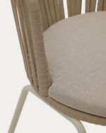 Close-up of a chair with woven backrest and beige cushion on a white background