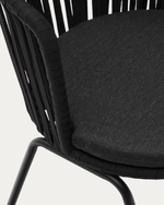 Black chair with woven backrest and dark cushion on a white background