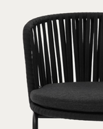Black wicker chair with a gray cushion on a white background