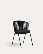A modern black dining chair with a curved slatted backrest and a thick black cushioned seat, shown against a plain light gray background.