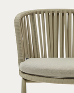 Close-up of a wicker chair with a cushion on a white background