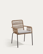 A modern outdoor armchair with a woven wicker frame, black metal legs, and a light gray cushion, shown against a plain off-white background.