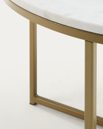 Close-up of a round table showing a white marble top and a brushed gold metal frame and legs against a clean white background.