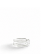 A small clear glass dish or shallow round glass container with a thick rim, photographed on a seamless white background.