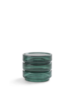 A small round green glass container with a ribbed, stacked design, shown on a clean white background.