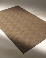 Brown textured rug on a plain background