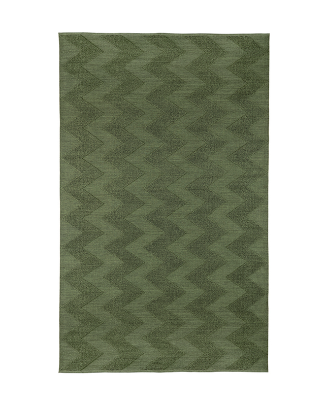 Green rug with zigzag pattern on a white background