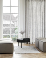 Arc Coffee Table in black styled in a contemporary living room — Scandinavian furniture piece with rotating lid and hidden storage.