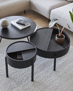 Close-up of Arc Coffee Table’s black painted ash veneer and dark grey nanolaminate interior of hidden storage.