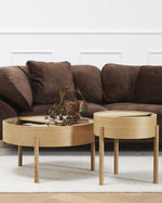 Arc Coffee Table in oiled oak styled in a contemporary living room — Scandinavian furniture piece with rotating lid and hidden storage.