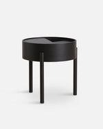 Arc Side Table in black with rotating lid and hidden storage, featuring a three-legged base and geometric design.