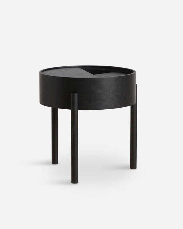 Arc Side Table in black with rotating lid and hidden storage, featuring a three-legged base and geometric design.