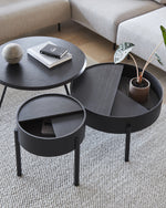 Arc Side Table in black with lid open showing hidden storage lined with smooth nanolaminate, three-legged base.