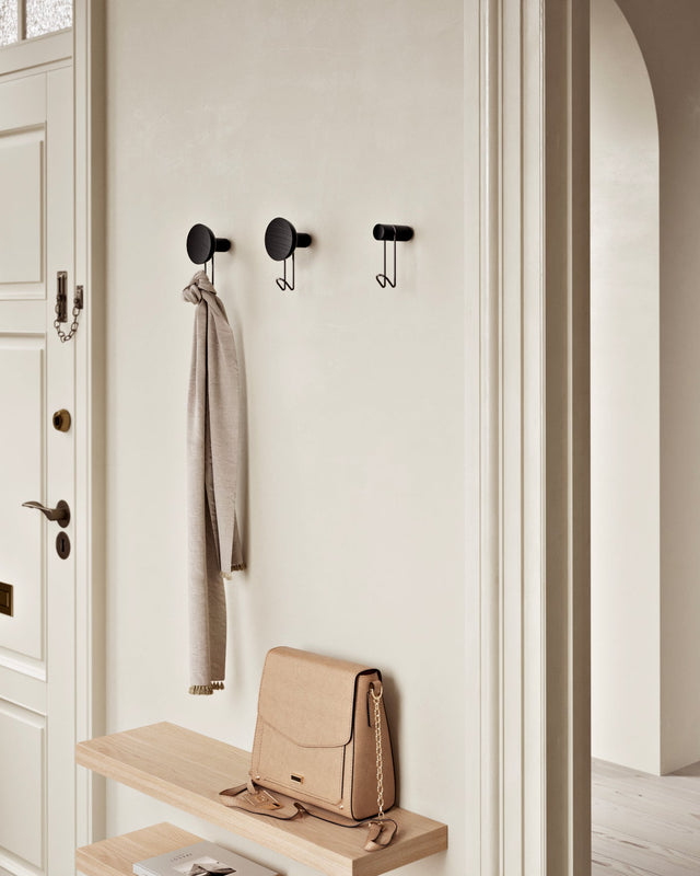 Around wall hanger (black & black) installed in hallway — decorative & functional wall hook.