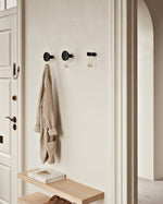 Around wall hanger (black & satin brass) installed in hallway — decorative & functional wall hook.