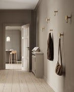 Around wall hanger (oat & black) installed in hallway — decorative & functional wall hook.