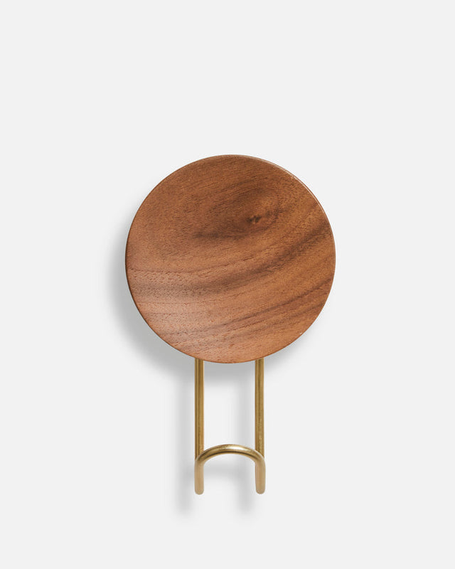 Detail of solid walnut wood grain and satin brass metal of large Around wall hanger.