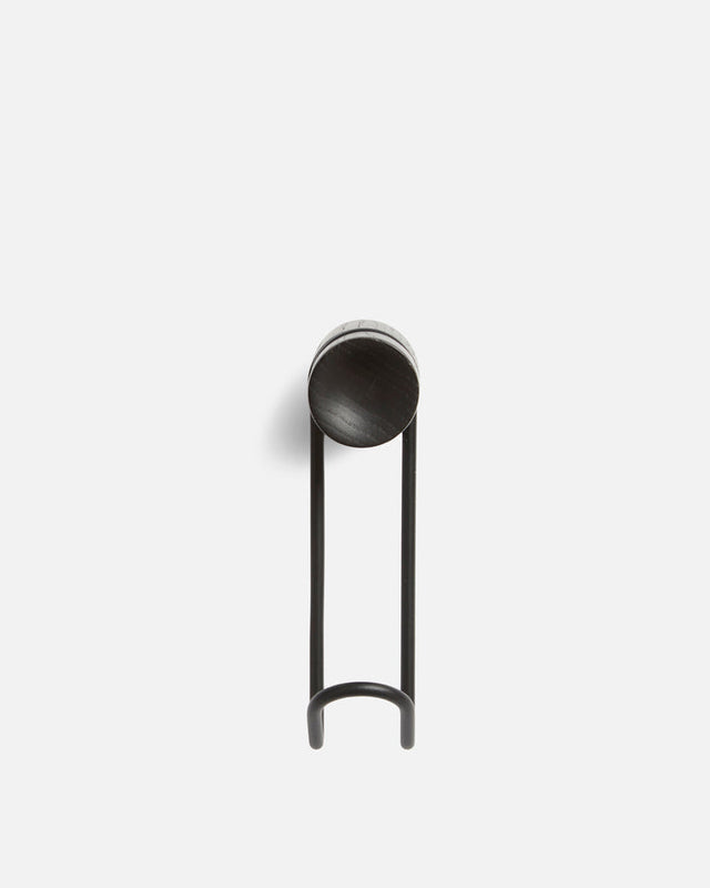 Detail of solid black wood grain and black metal of large Around wall hanger.