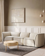 Flora 2.5 Seater in Natural bouclé styled in a modern living room with minimalist décor.