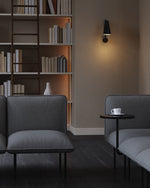 Nakki Lobby Side Table in black styled with modular seating in a modern setting.