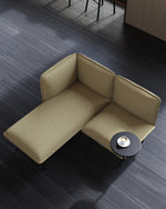 Nakki Lobby Side Table in black styled with modular seating in a modern lounge or lobby.