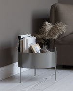 Close-up of the taupe painted metal surface texture of Pidestall Planter Medium