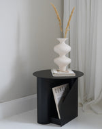 Detailed view of the two storage slots on the Sentrum Side Table for magazines/books.