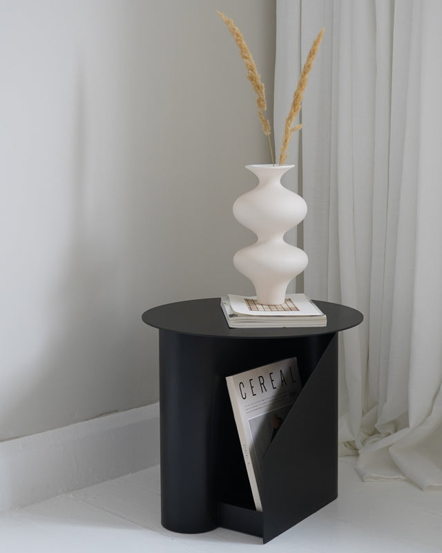 Detailed view of the two storage slots on the Sentrum Side Table for magazines/books.